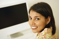 A woman is working on her computer.