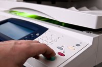 Man's finger pushing a photocopier's start button.