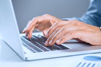 Type notes on a laptop.