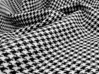 A close-up of black and white houndstooth fabric.