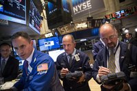 Three brokers at work at the New York Stock Exchange