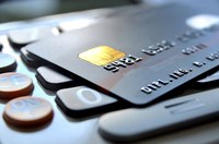 Credit card laying on top of a keyboard.