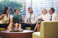 A group of business colleagues meeting in a common area