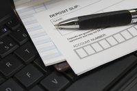 A pen on top of a deposit slip.