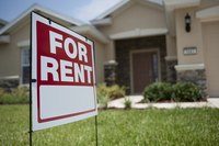 For rent sign in front a house.