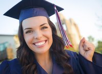 Smiling graduate student in cap and gown