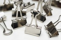 Several binder clips laying on a table