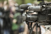 Professional video cameras covering an event.