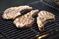 Pork chops being grilled.