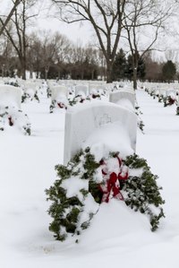 Make an extra wreath for a grave that never has any flowers in honor of Christmas.