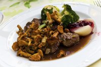 Roasted venison tenderloin topped with chanterelles.