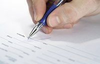 Image of a man signing a mortgage document.
