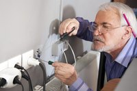 A close-up of an electrician at work.