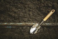 Pipes, soil and a shovel.
