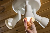 Close-up of a woman changing a light bulb