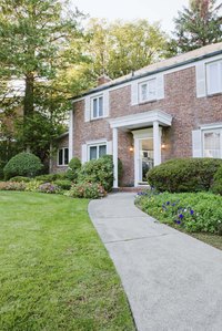 A poured sidewalk provides a long-lasting, welcoming touch to a front yard.