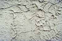 An exterior brick wall covered with stucco can have different textures.