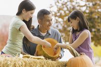 Pumpkin carving kits include scoops for cleaning the inside of your creation.