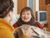 Two women having a conversation on the sofa.