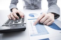 A business person analyzes documents.