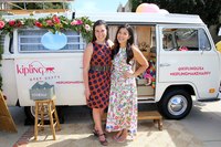 Two businesswomen promoting their products from a retro van on a college campus.