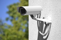 A security camera mounted on the corner of a building.