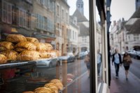 Pastries on display in the front window of a bakery.