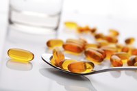 Spoonful of vitamin capsules