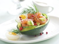 A salmon and egg salad served in a halved avocado