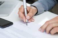 A man is signing a contract.