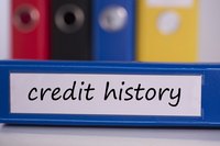 Person's credit history stored in a blue binder.