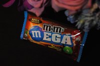 Someone is holding a bag of M&M's.