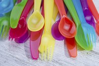 Multi-colored plastic cutlery on a table surface