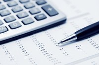 A calculator is resting on a business spreadsheet.