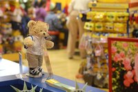 Teddy bear standing on counter inside teddy bear store