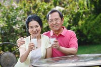 A mature couple drinking a glass of milk.
