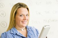 A female professional standing in front of a whiteboard at the office.