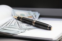 A close-up of an ink pen on top of bank notes.