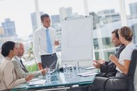 A man is giving a presentation to a group of business people.