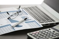 An investment chart, computer and calculator.