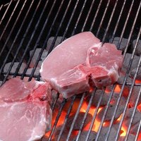 grilling pork chops on charcoal grill