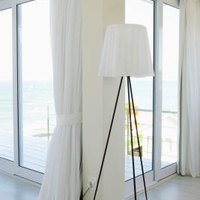 How to Hang Drapery Over Vertical Blinds That Just Cover the Patio Doors | eHow