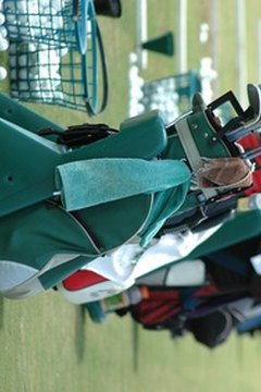 Players carry golf accessories in additon to clubs, balls and tees.
