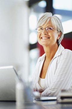 mature woman sitting in front of a laptop