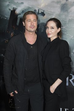 Angelina Jolie and Brad Pitt stop for photographers before entering a 2013 movie premiere.