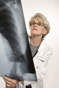 Senior healthcare worker holding x-ray
