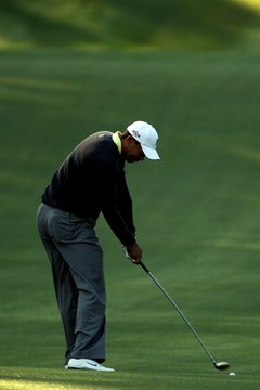 Tiger Woods' club head levels out at impact, indicating that his fairway wood has the correct lie angle.