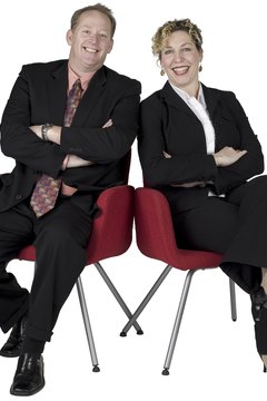 Businessman and businesswoman sitting and posing