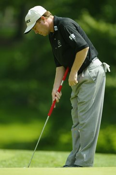 As Champions Tour player Jeff Sluman demonstrates, a belly putter should be anchored in the abdomen and centered a few inches above the waist.