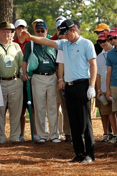 Justin Rose takes a drop during the 2012 Masters.